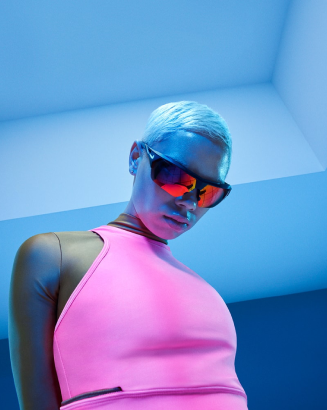 A lady wearing a pink shirt and sunglasses